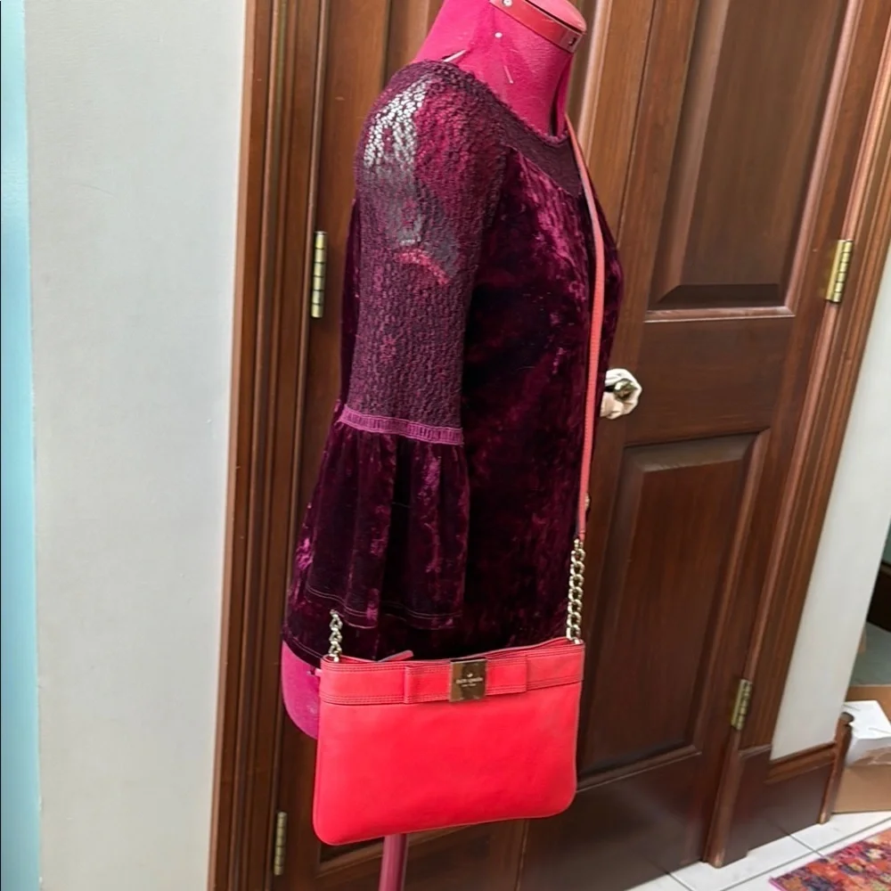 Kate Spade   Crossbody bag  leather orangeish red   bow on front chain strap det